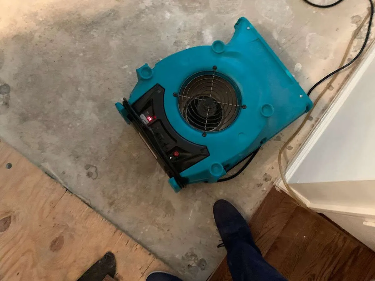 Air mover drying subfloor during Commercial Water Damage Restoration in Oberlin